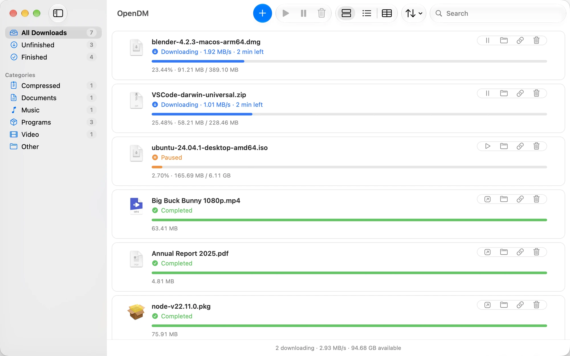 The OpenDM window: two downloads in progress, one paused and several finished, sorted into categories in the sidebar